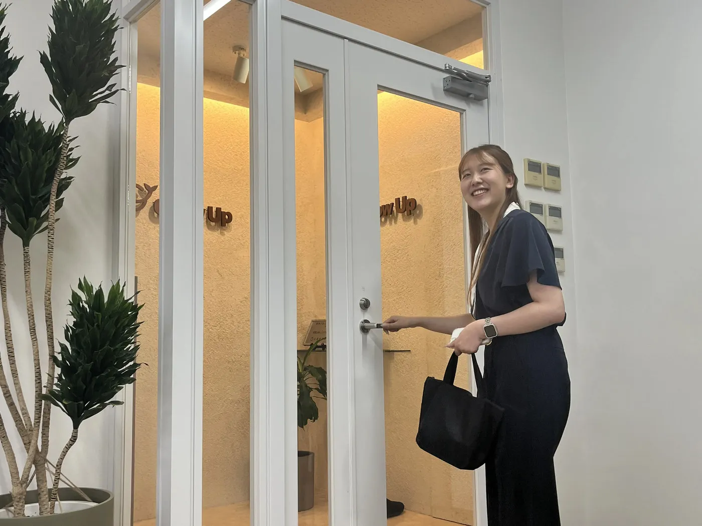 ガラスドアで振り返り退社する社員